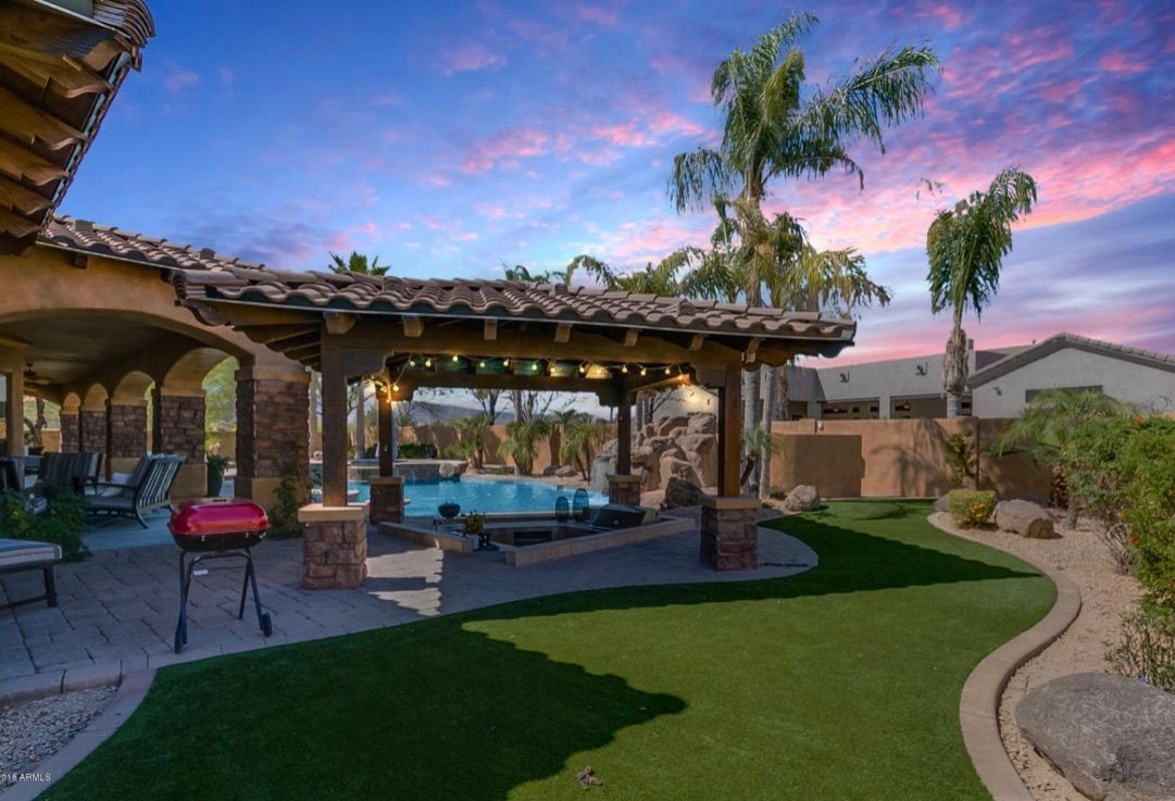 A house with a gazebo and a pool in the backyard.