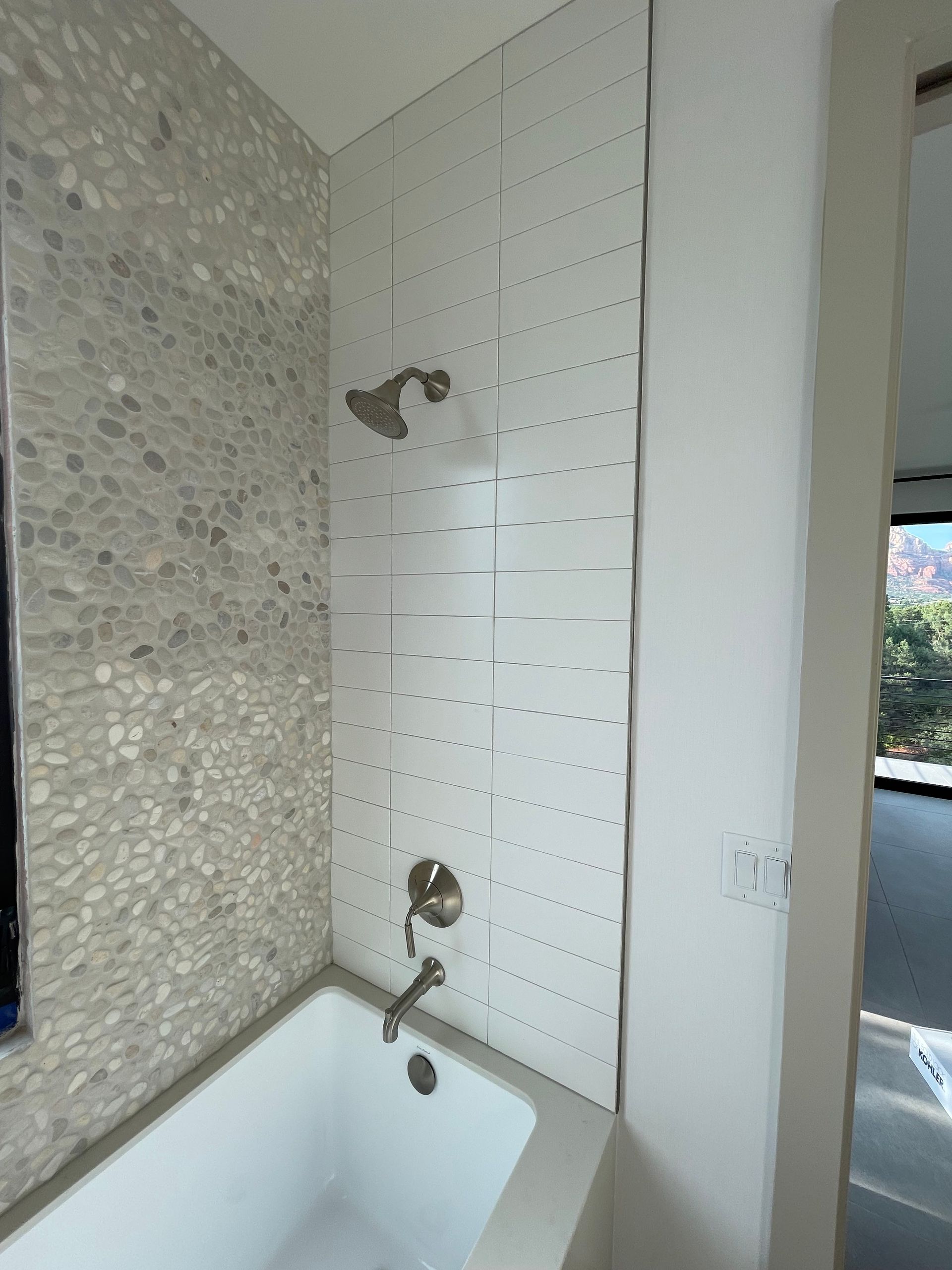 A bathroom with a bathtub and a shower