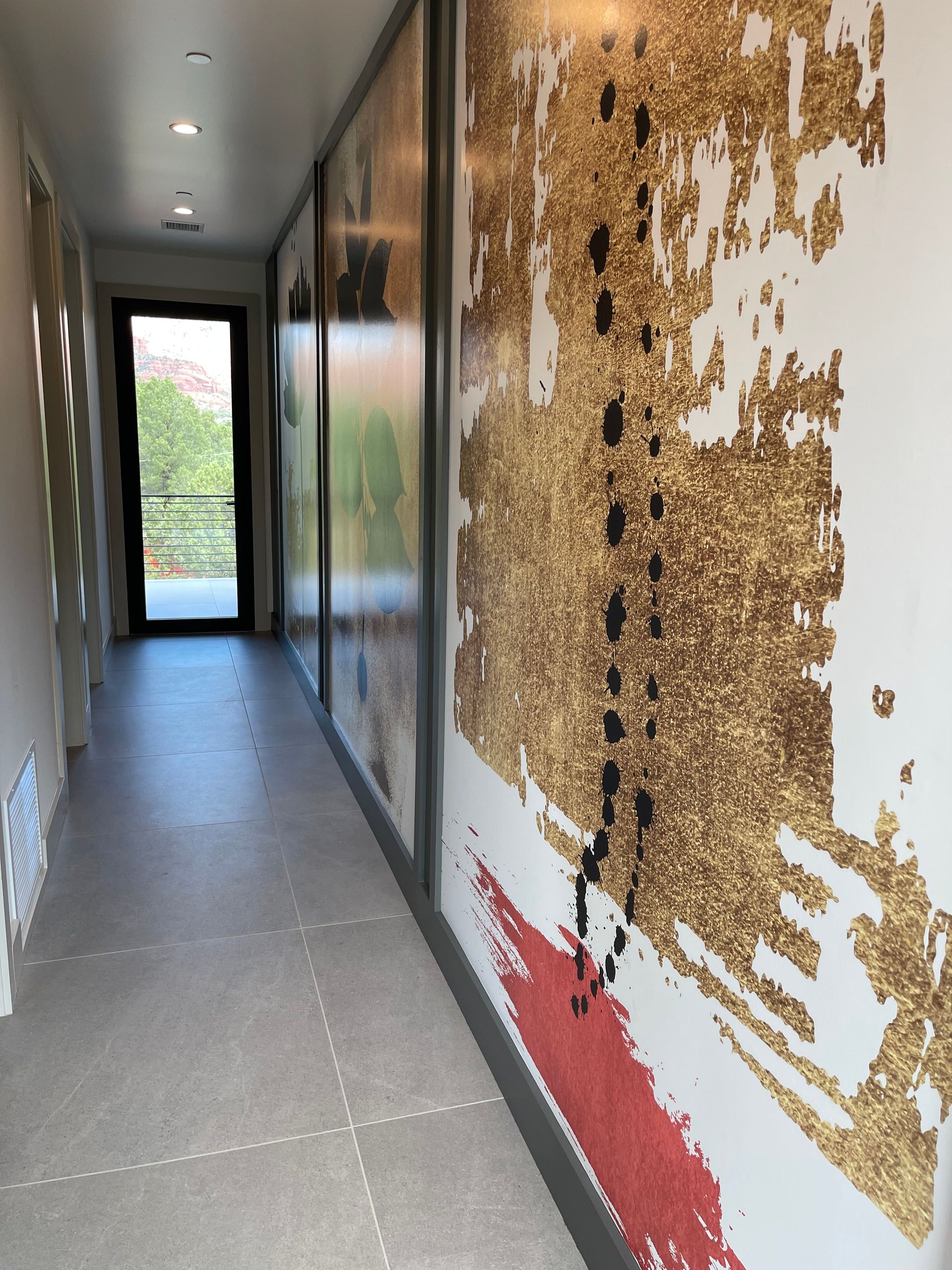 A long hallway with a painting on the wall