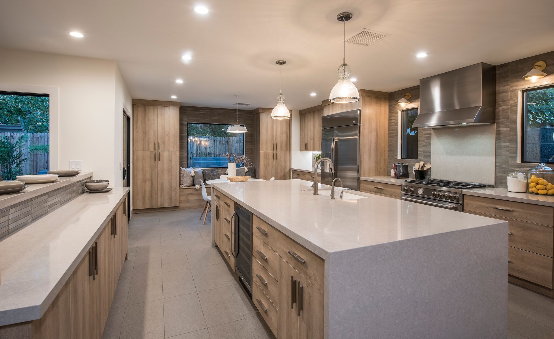 A kitchen with a large island and stainless steel appliances.