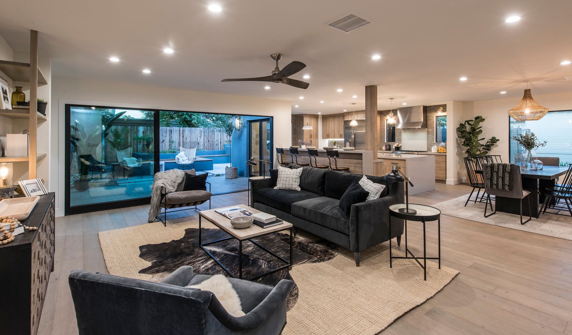 A living room filled with furniture and a ceiling fan.
