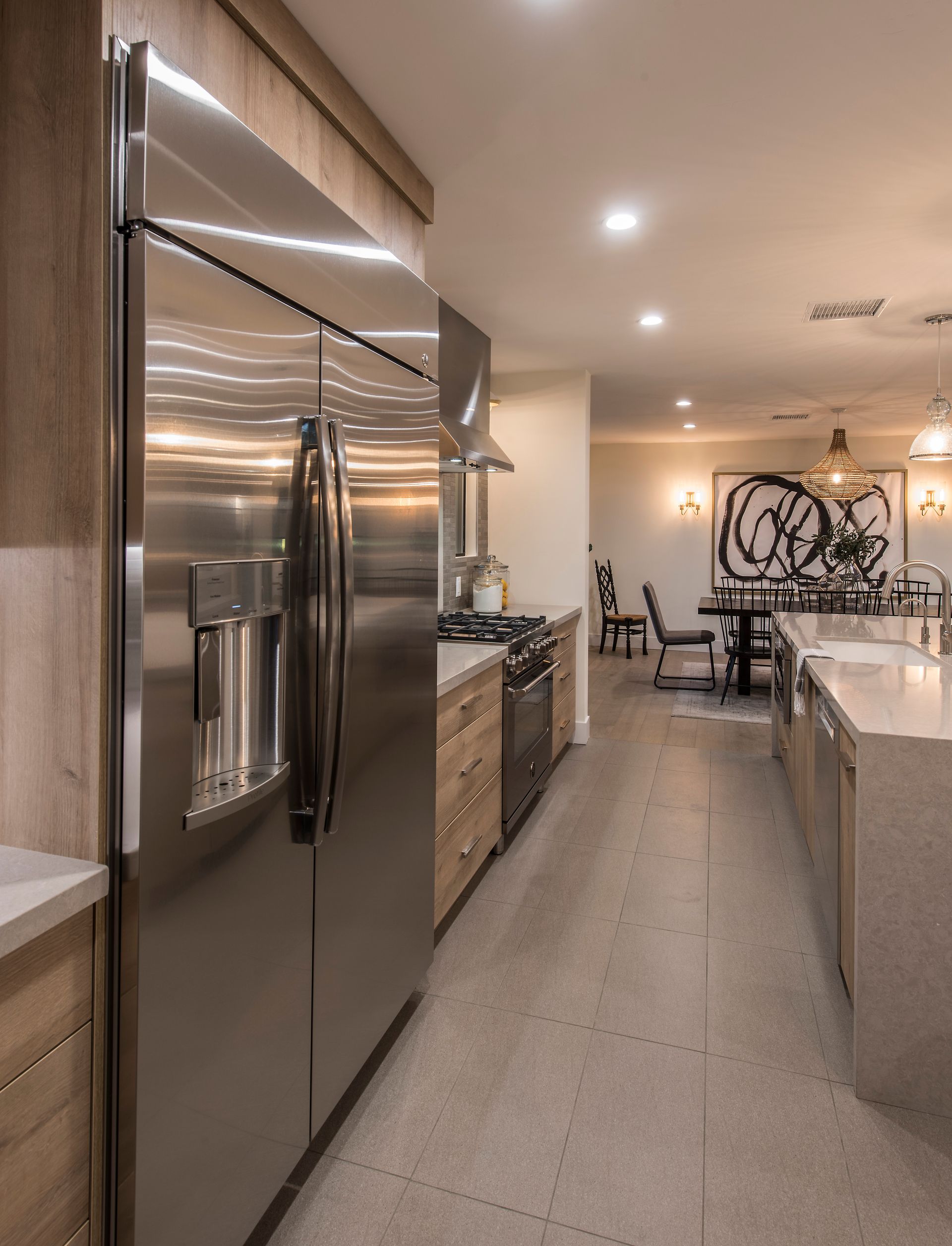 A kitchen with stainless steel appliances and a large refrigerator
