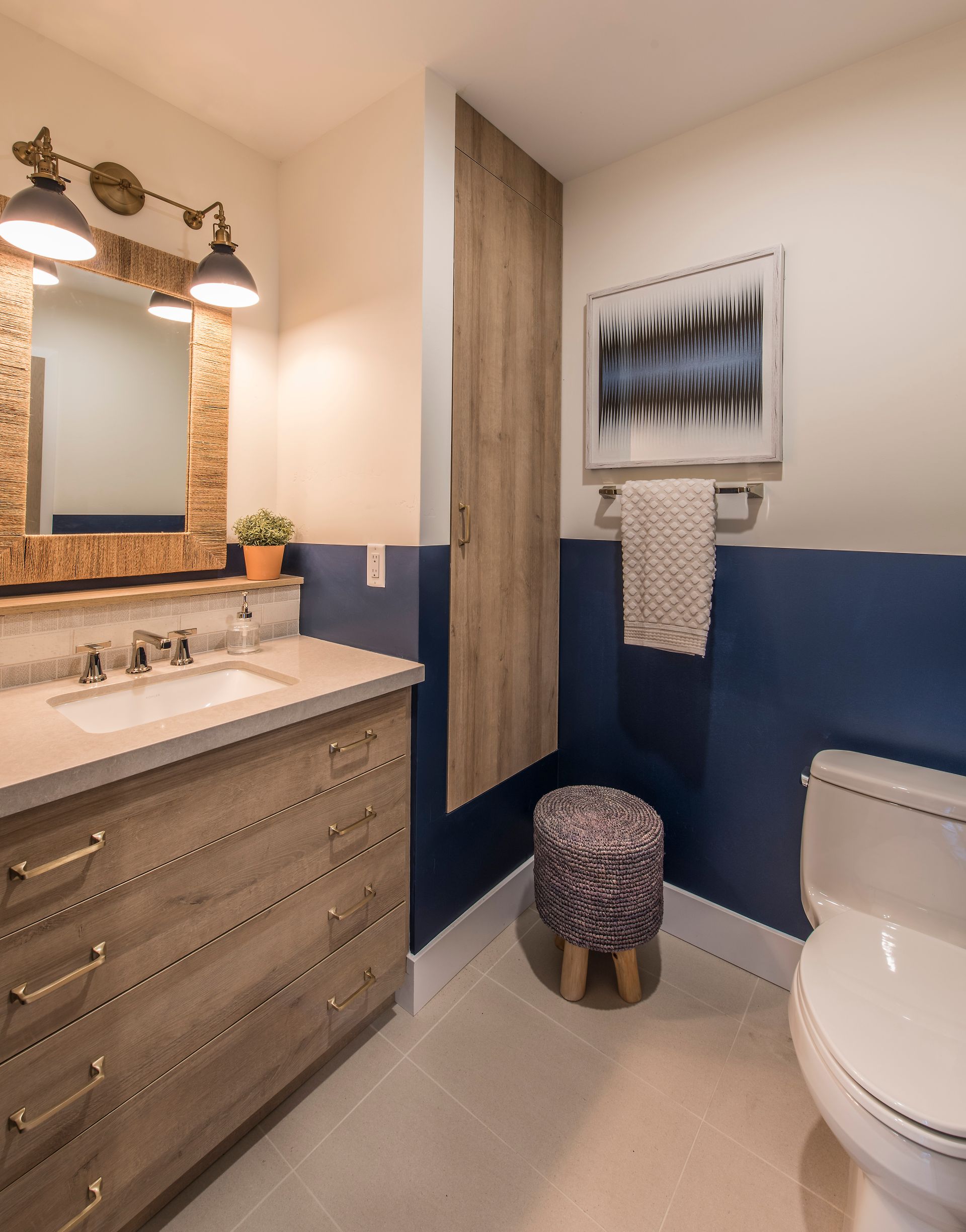 A bathroom with a toilet a sink and a mirror