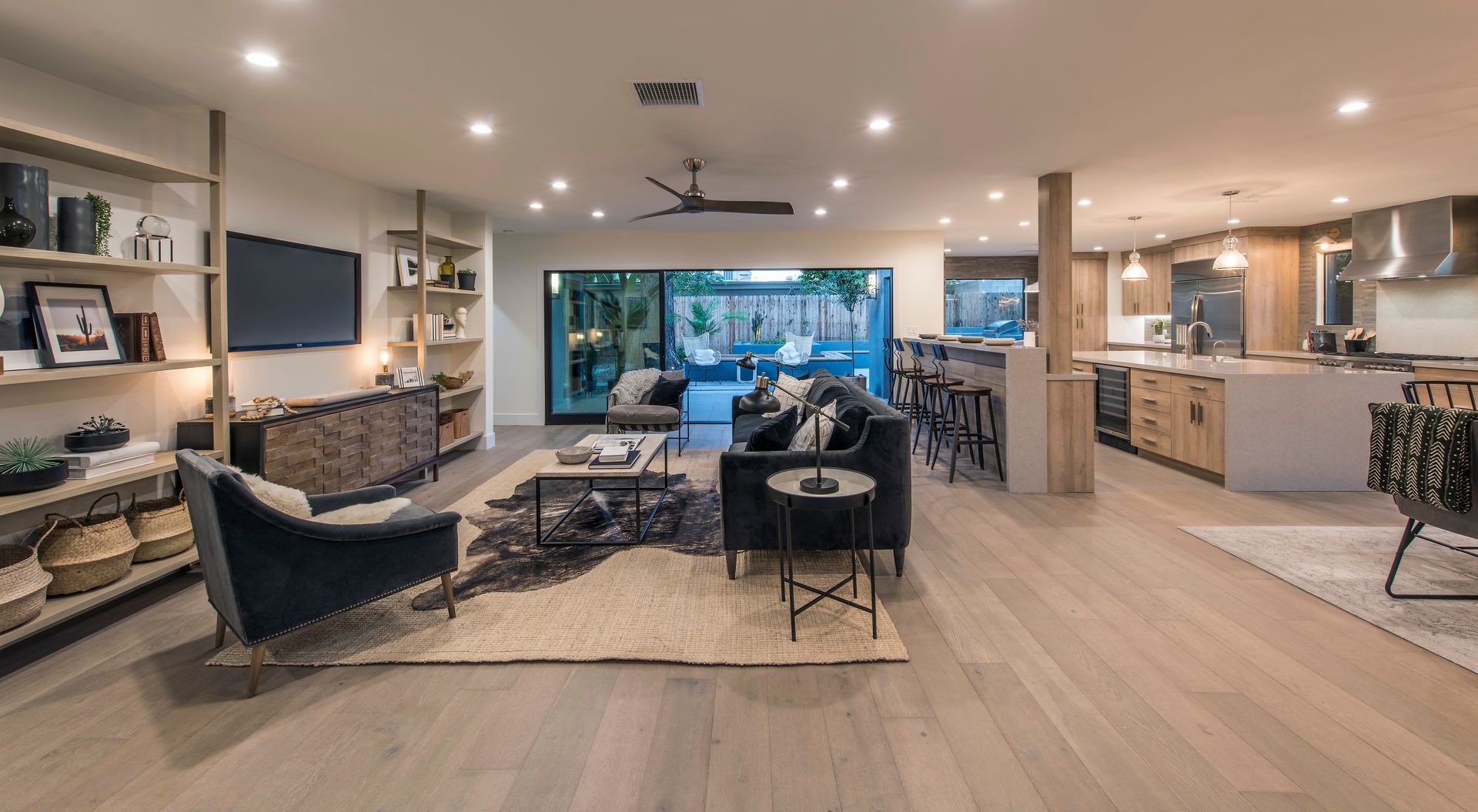 A living room with a couch , chairs , and a television.