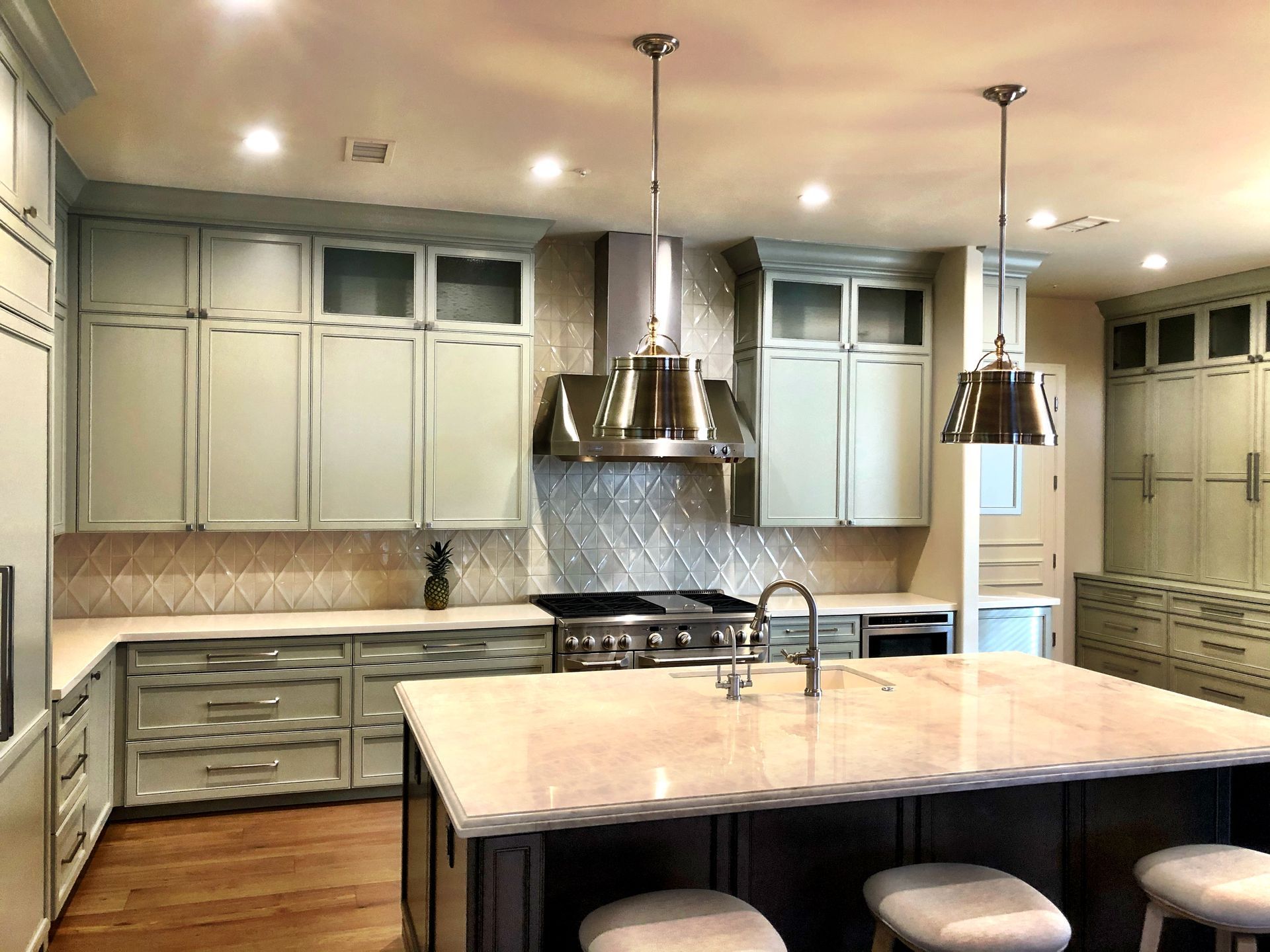 A kitchen with a large island and stools