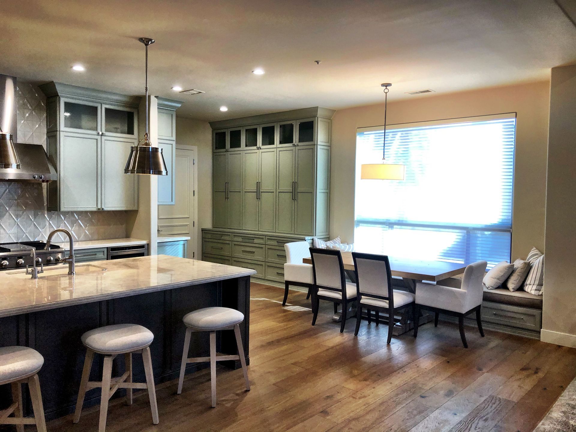 A kitchen with a large island and a dining table
