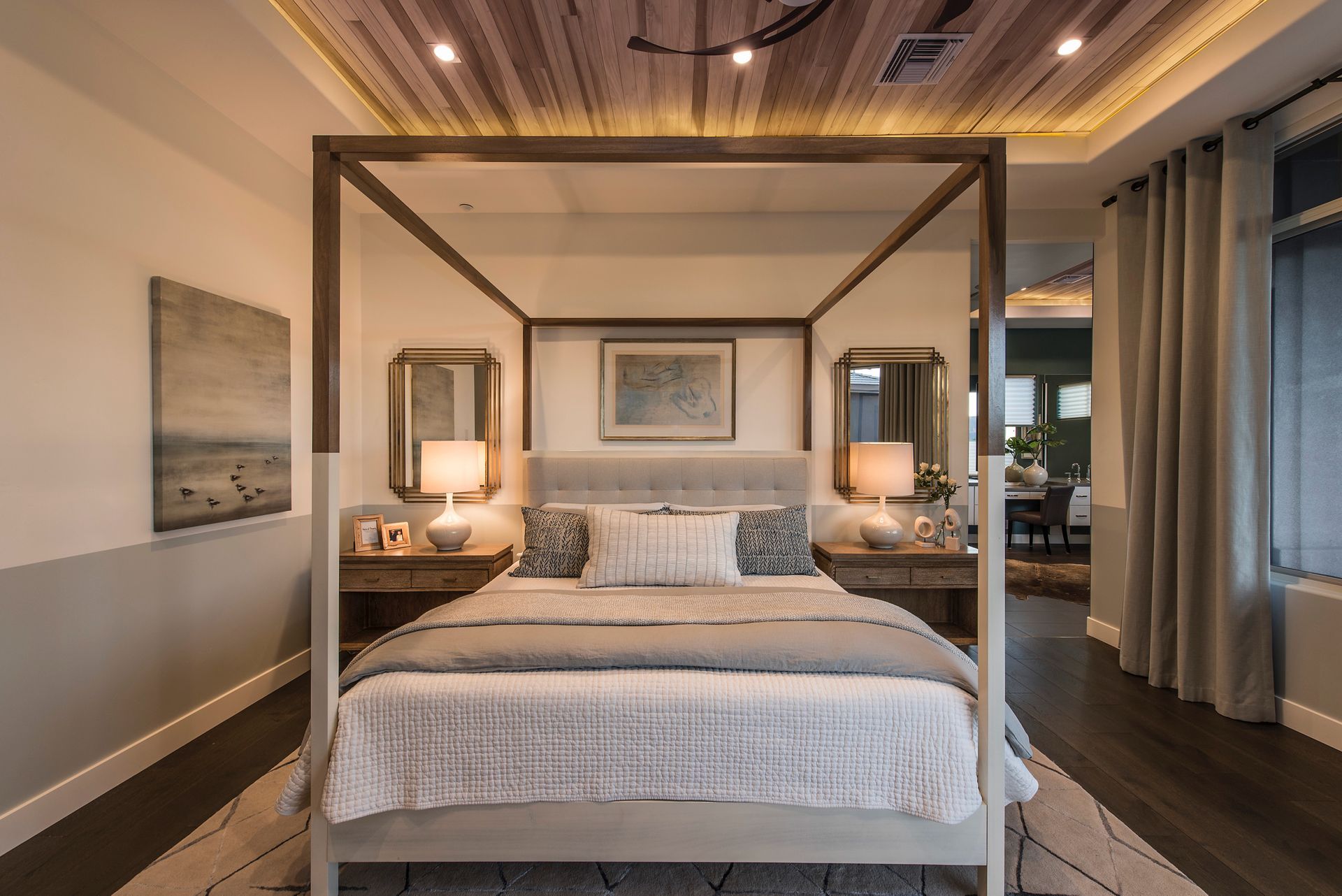 A bedroom with a canopy bed and a wooden ceiling.