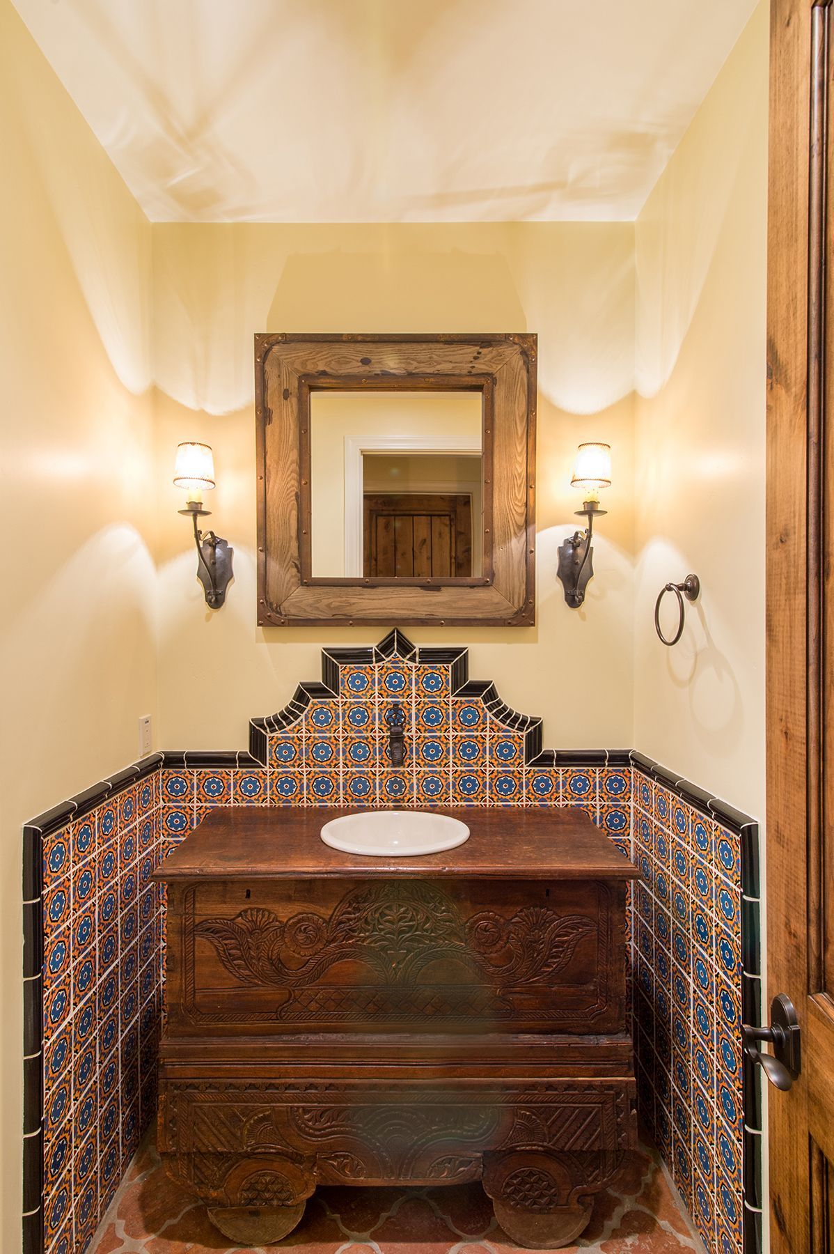 A bathroom with a sink and a mirror on the wall.