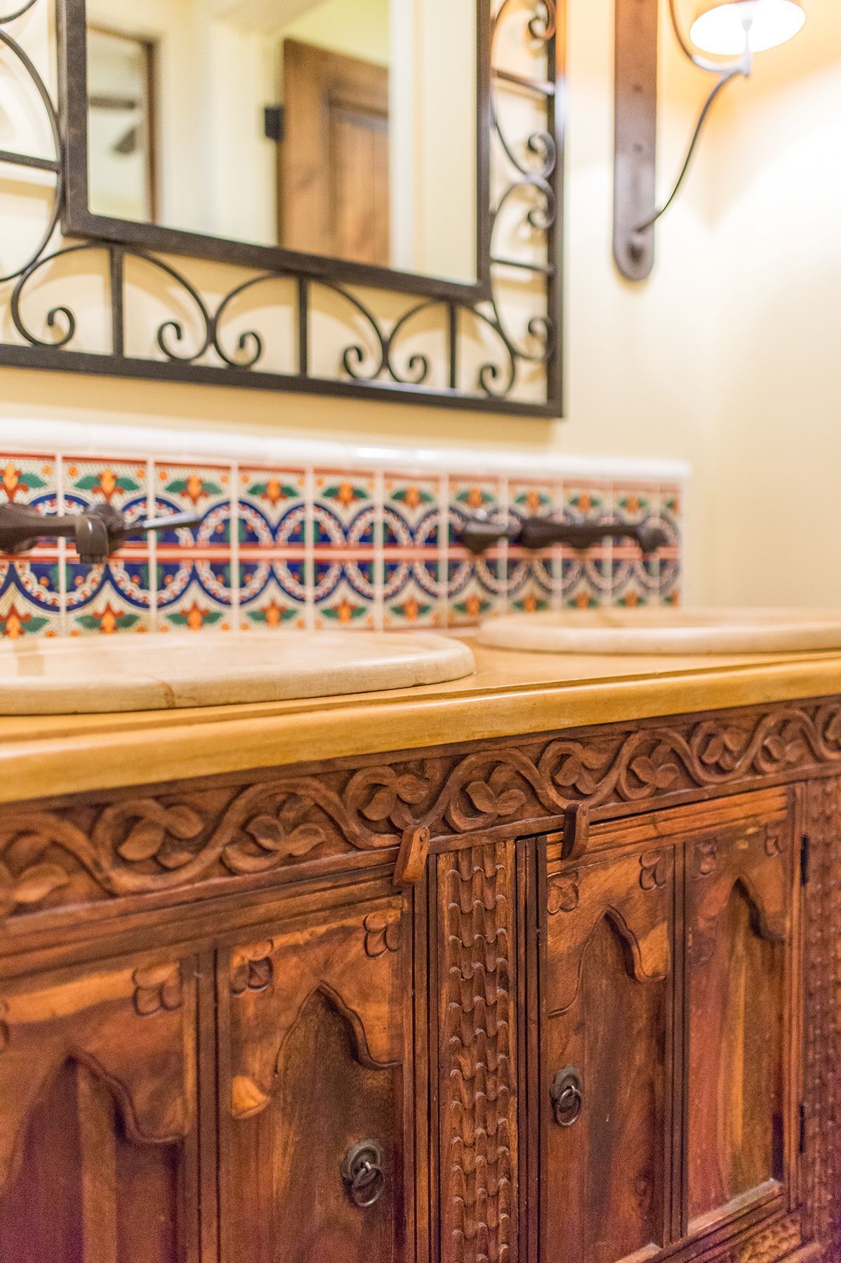 A bathroom with two sinks and a mirror.