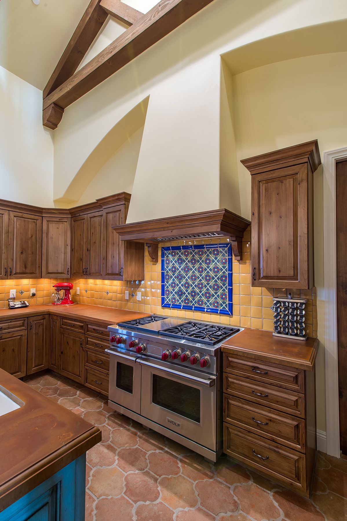A kitchen with stainless steel appliances and wooden cabinets
