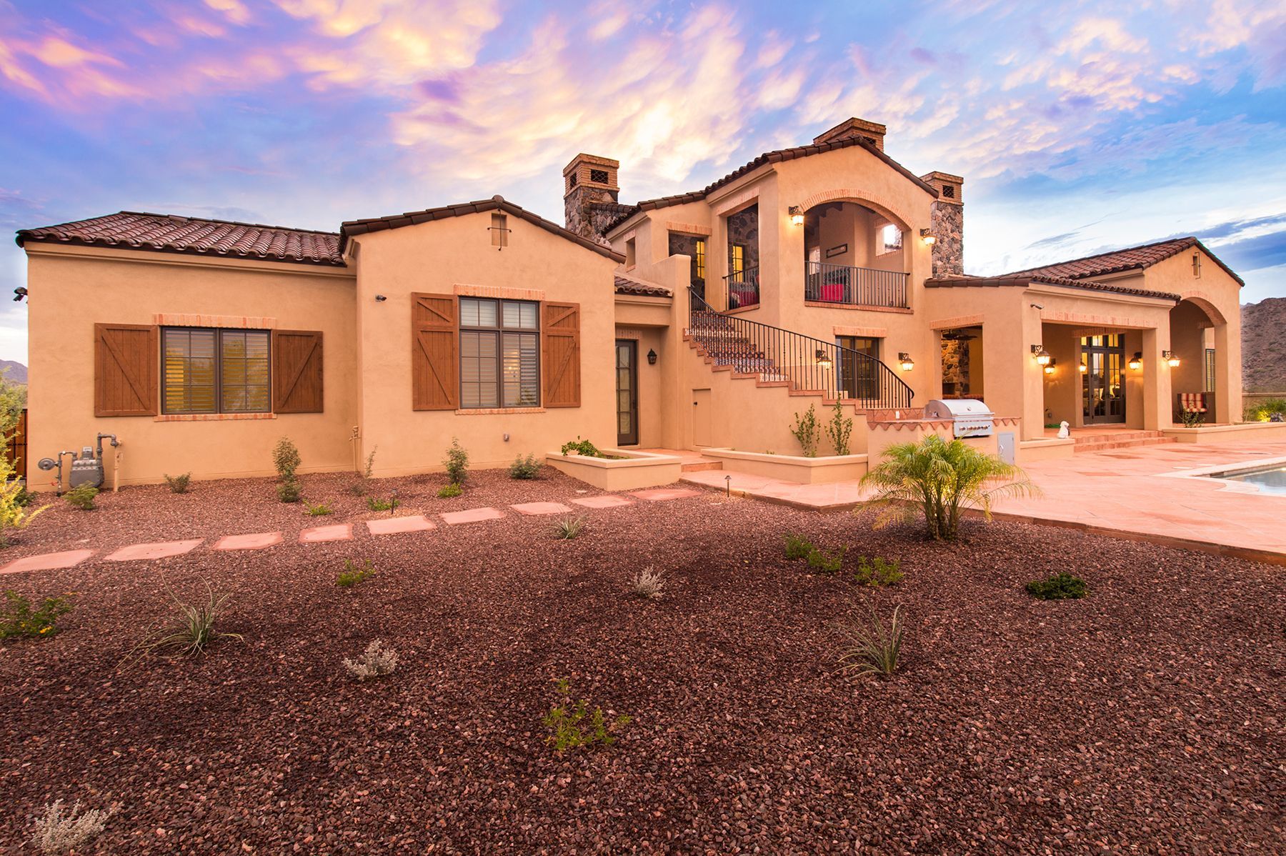 A large house with a swimming pool in front of it.