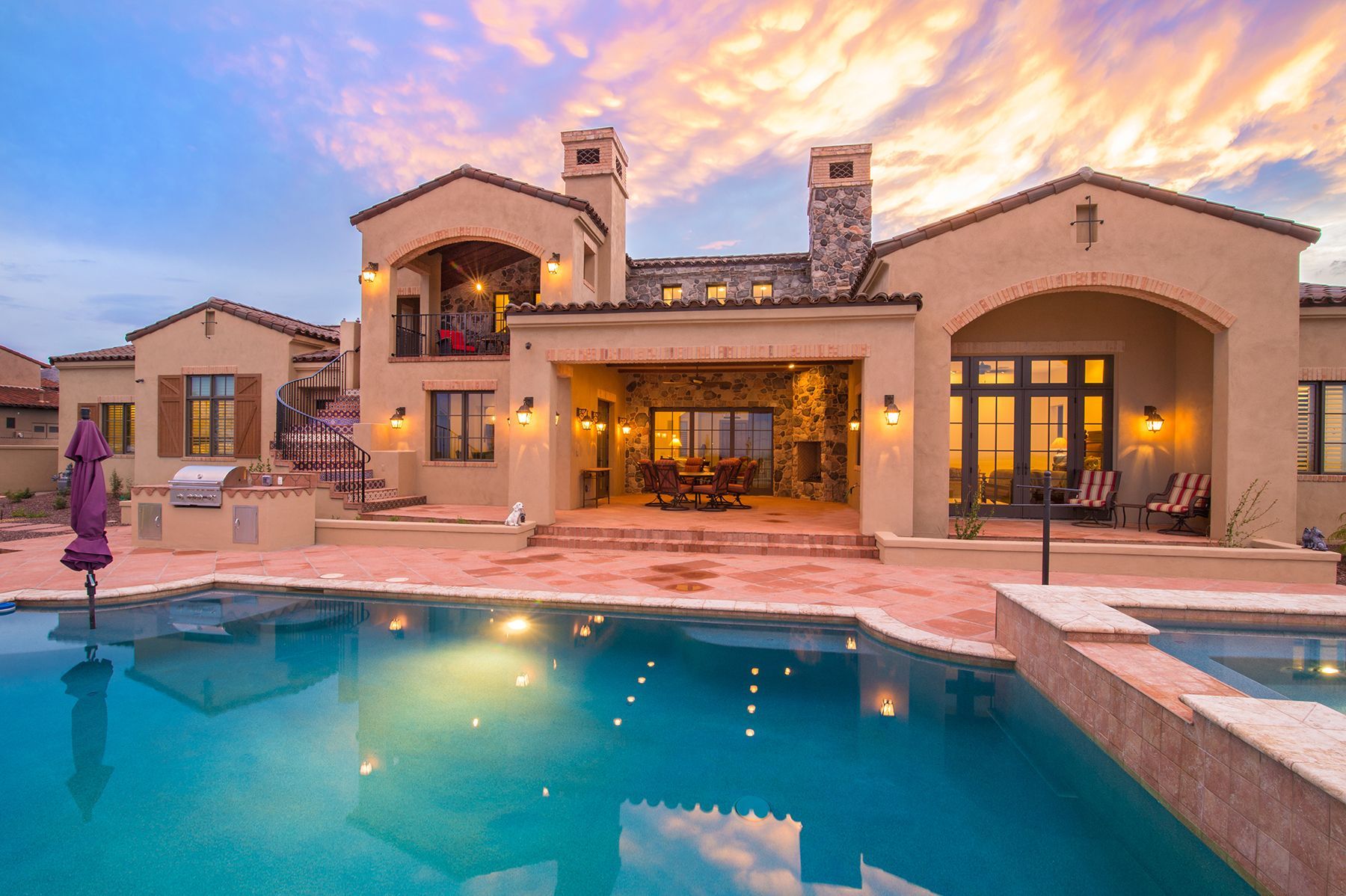 A large house with a large swimming pool in front of it.