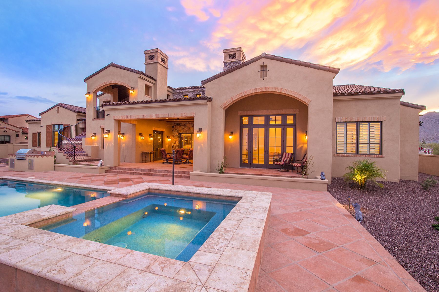 A large house with a swimming pool in front of it.