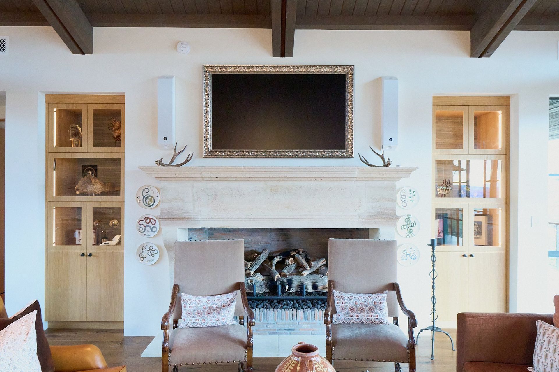 A living room with a fireplace and a flat screen tv above it