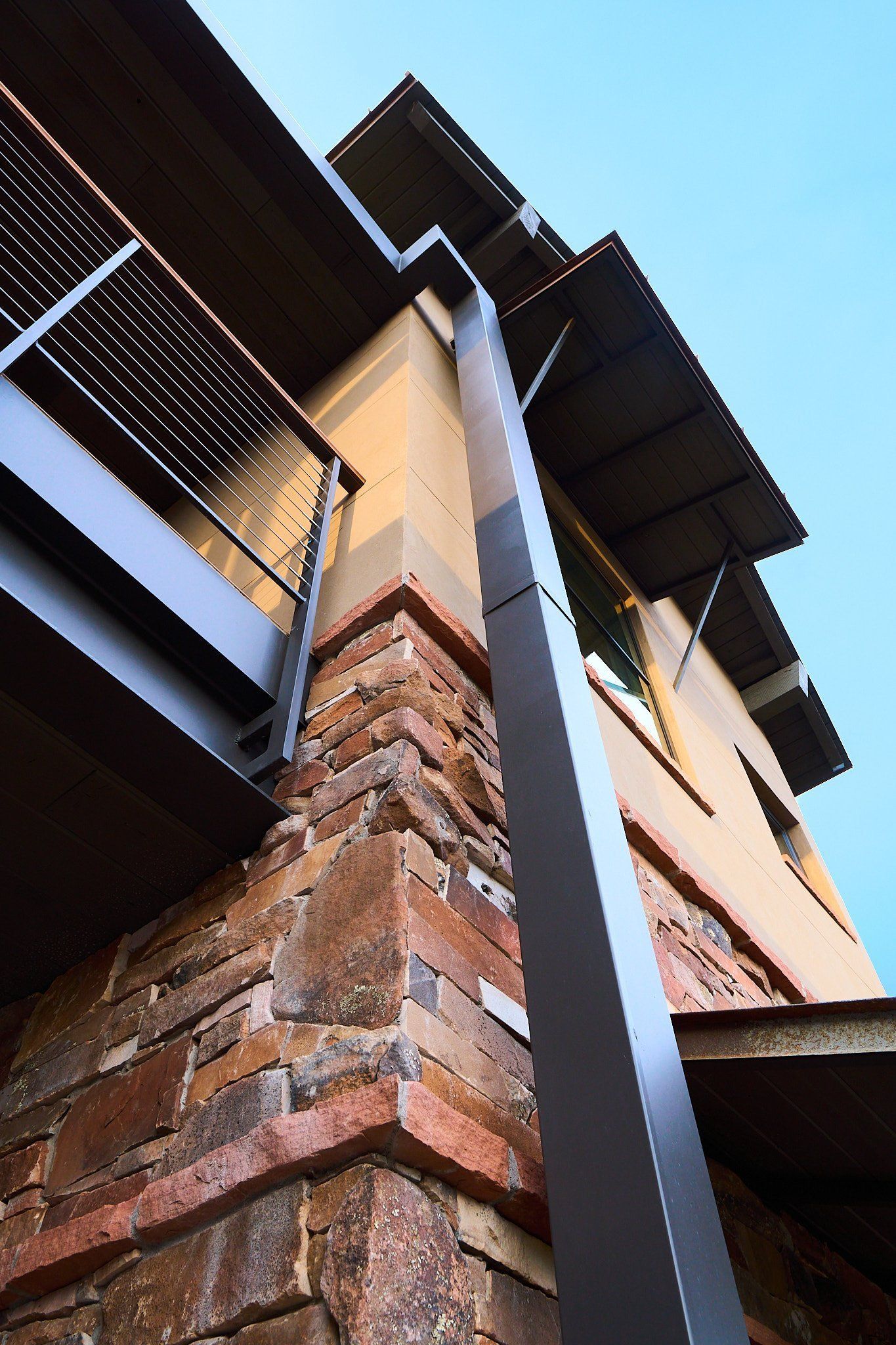 Looking up at the corner of a building with a gutter