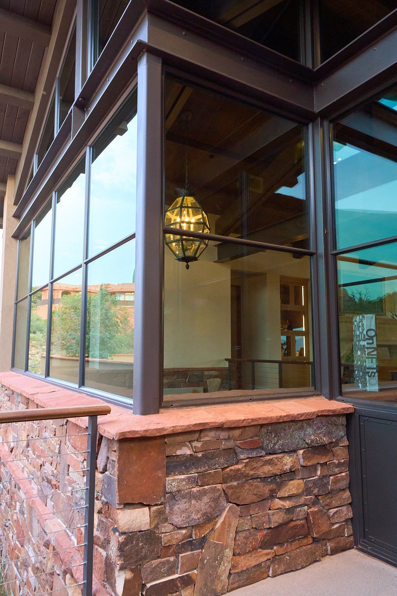 A building with a lot of windows and a stone wall.