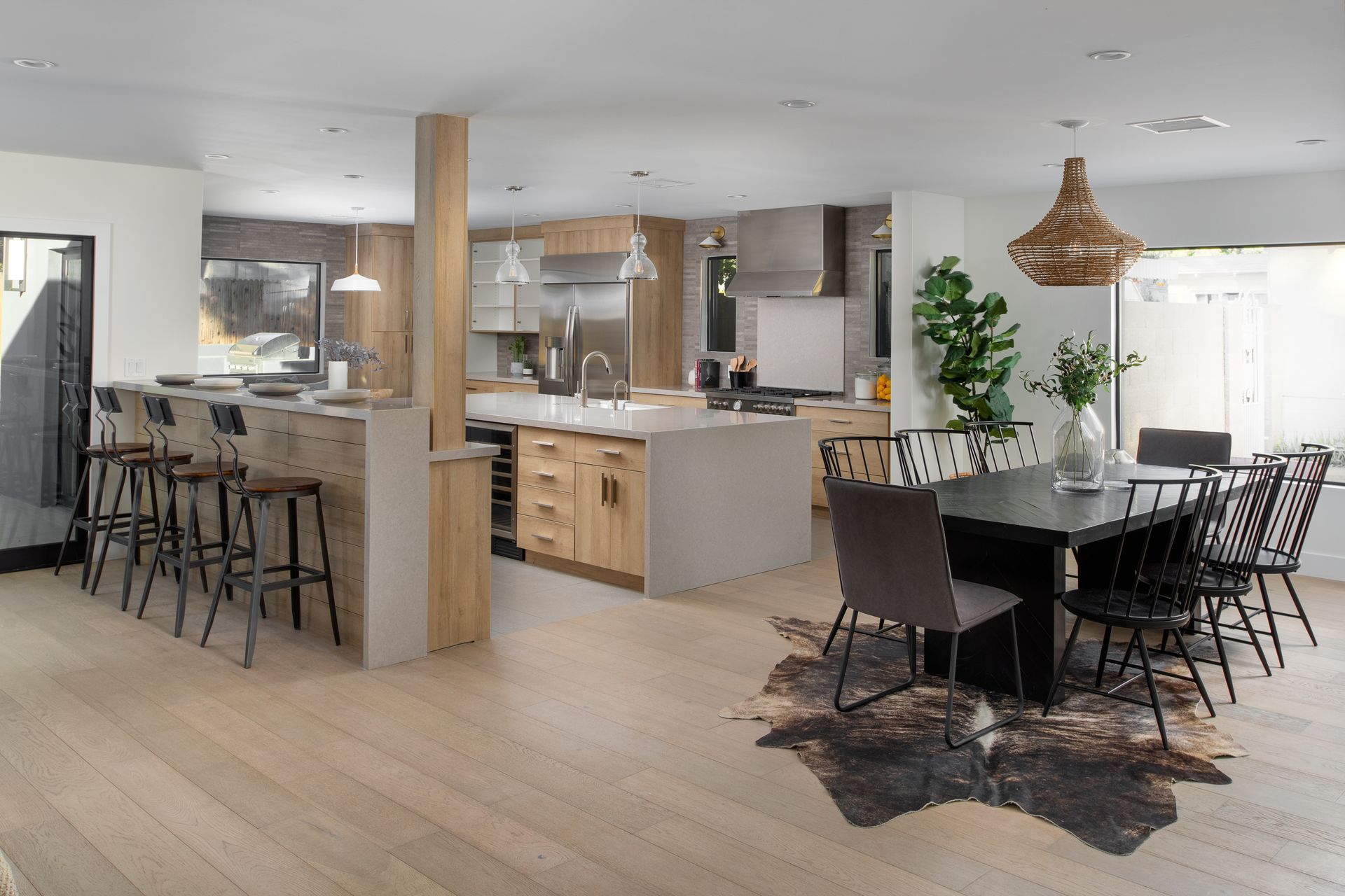 A kitchen and dining room with a cowhide rug on the floor.