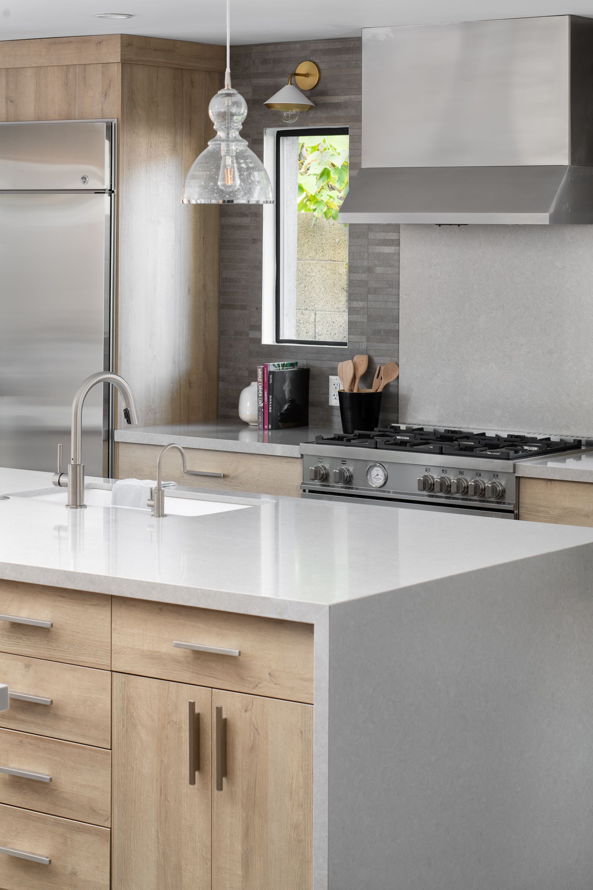 A kitchen with stainless steel appliances and wooden cabinets.