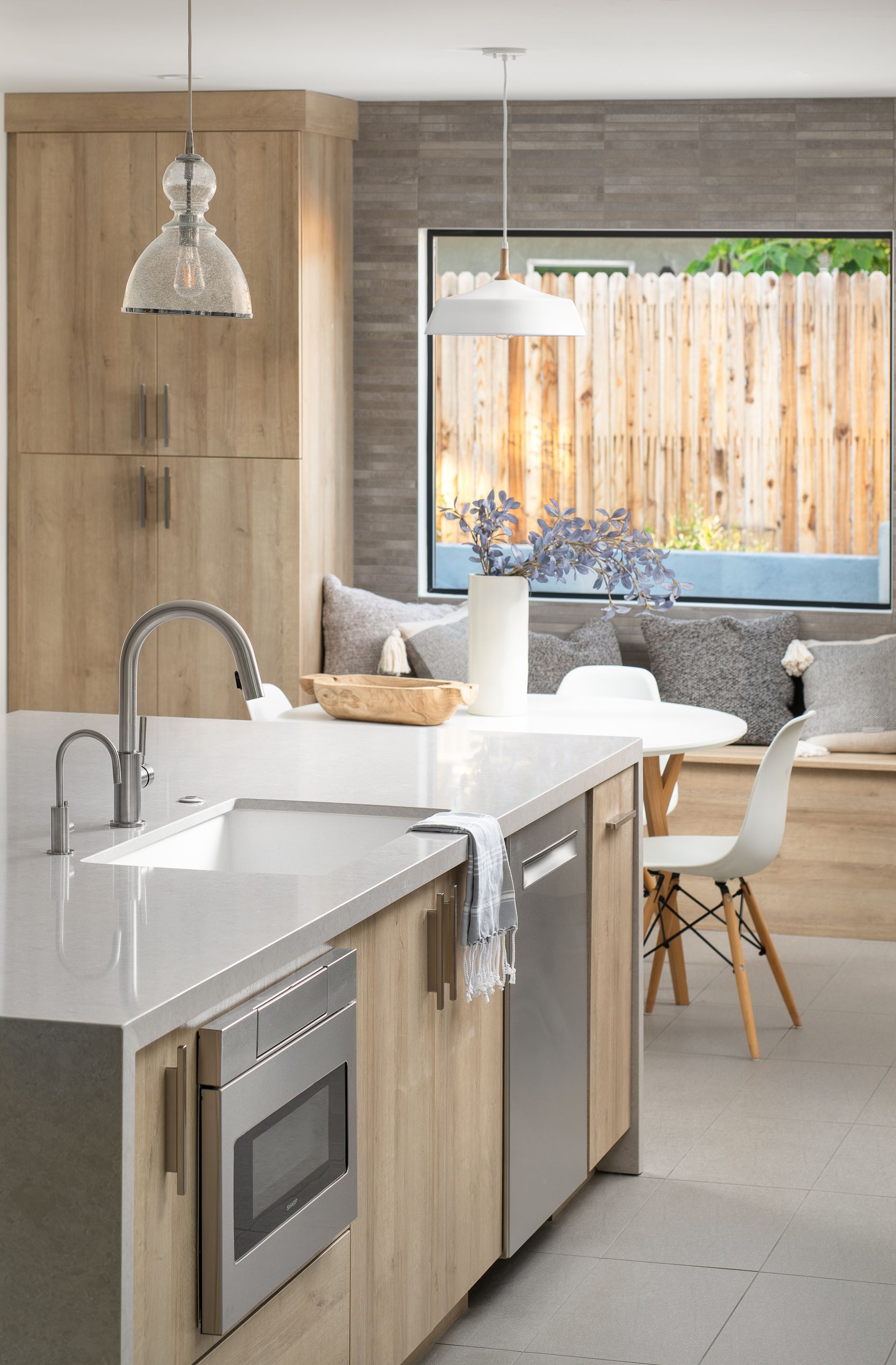 A kitchen with stainless steel appliances and wooden cabinets.