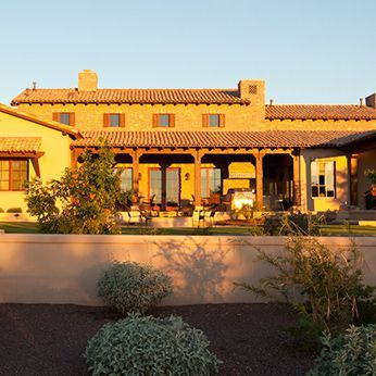 A large house with a covered porch and lots of windows