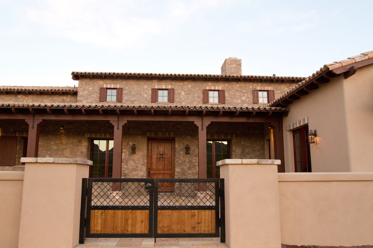 A large house with a wooden gate in front of it