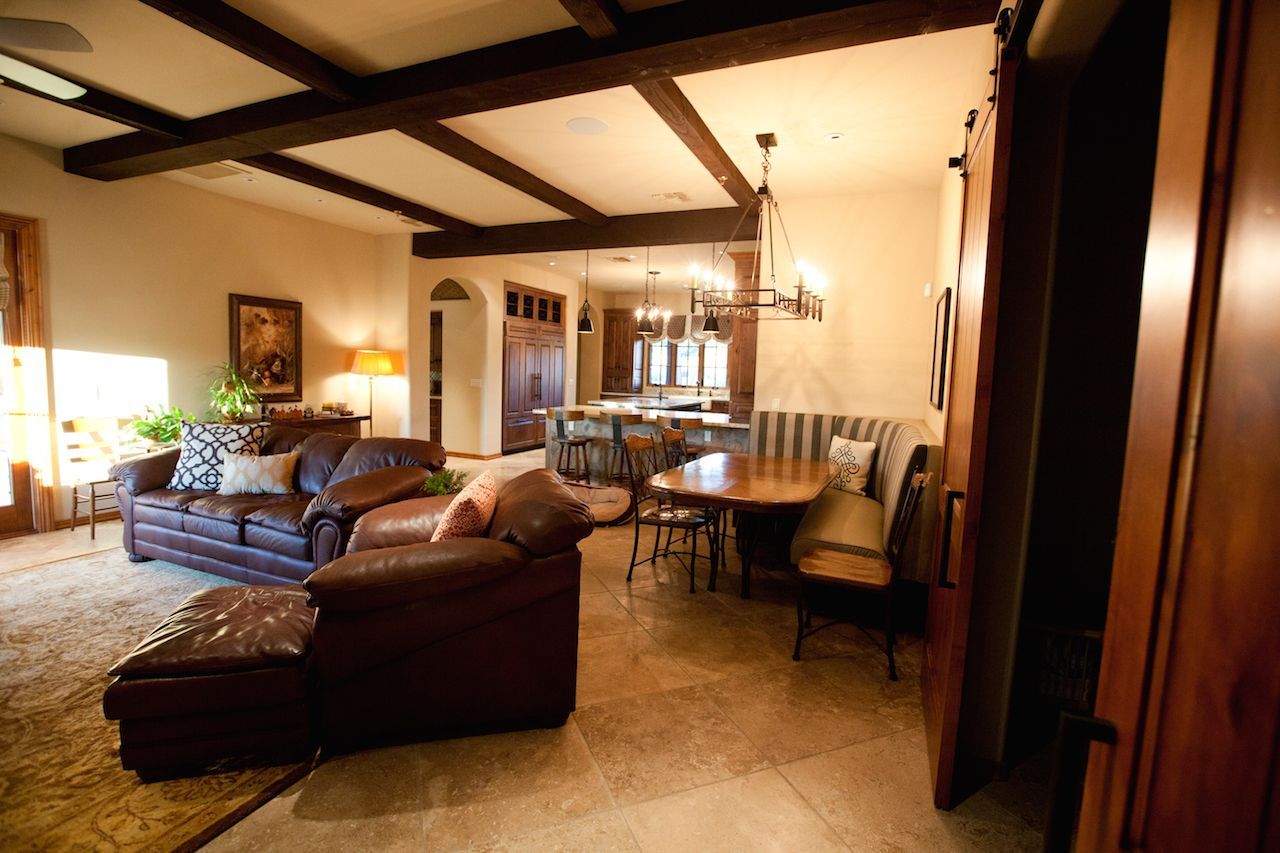 A living room with a couch and chairs and a table