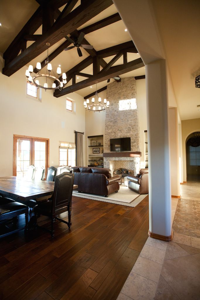 A living room with a fireplace , couch , table and chairs.
