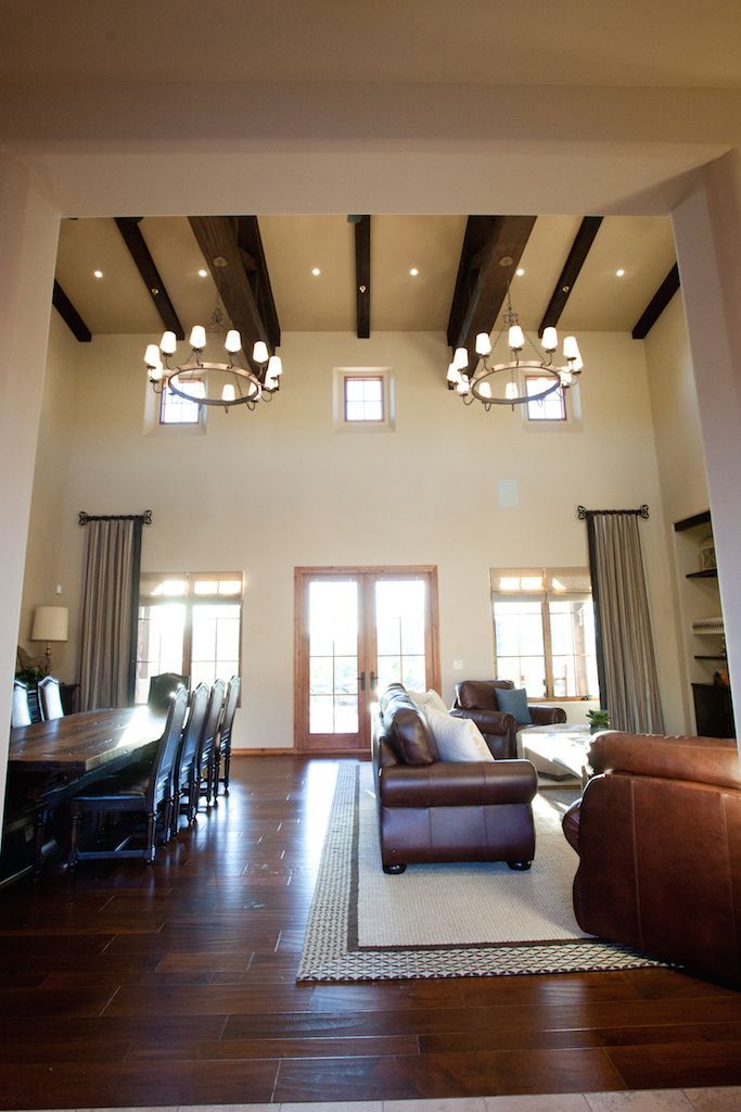 A living room with two chandeliers hanging from the ceiling