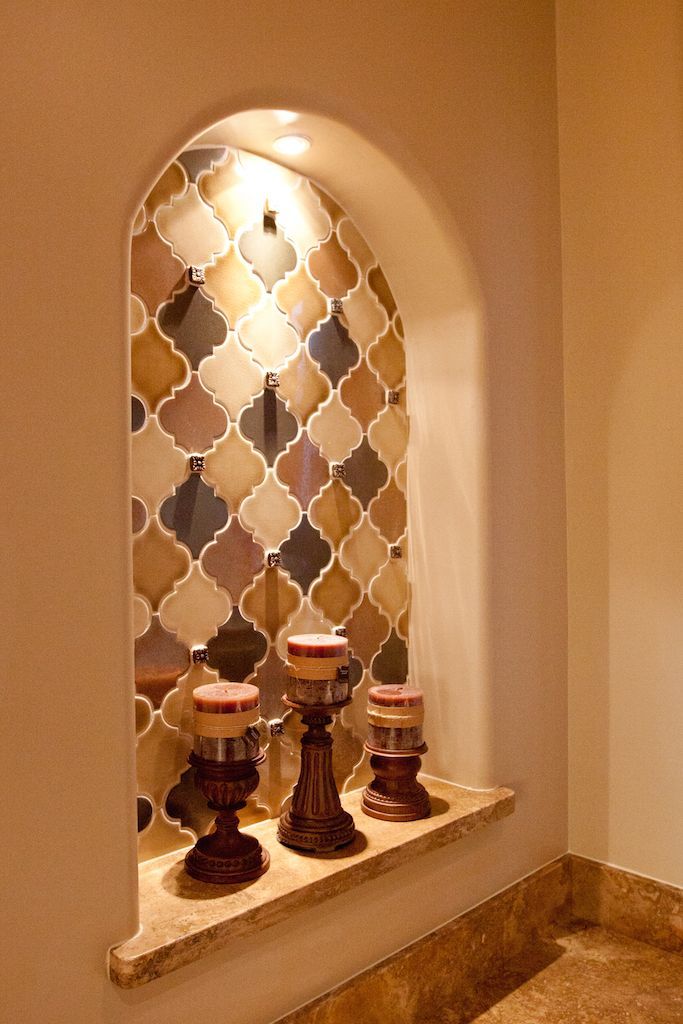 A niche in a wall with candles in it