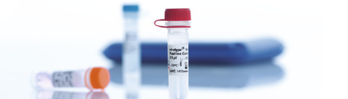 A close up of a test tube with a red cap