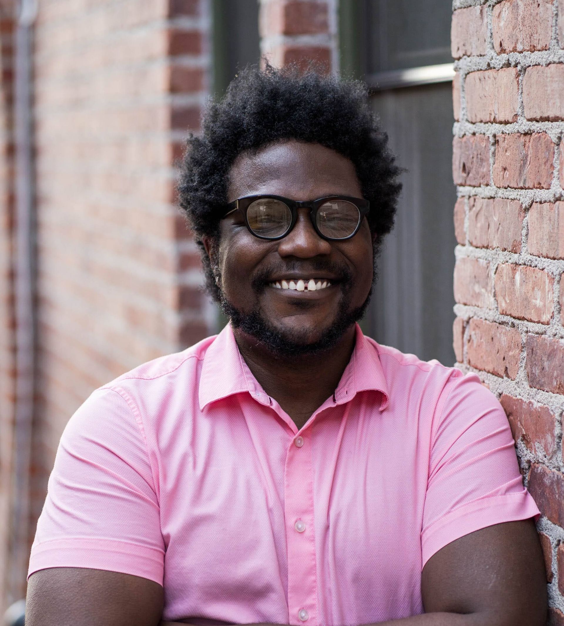 Dorian Capers leaning on brick wall