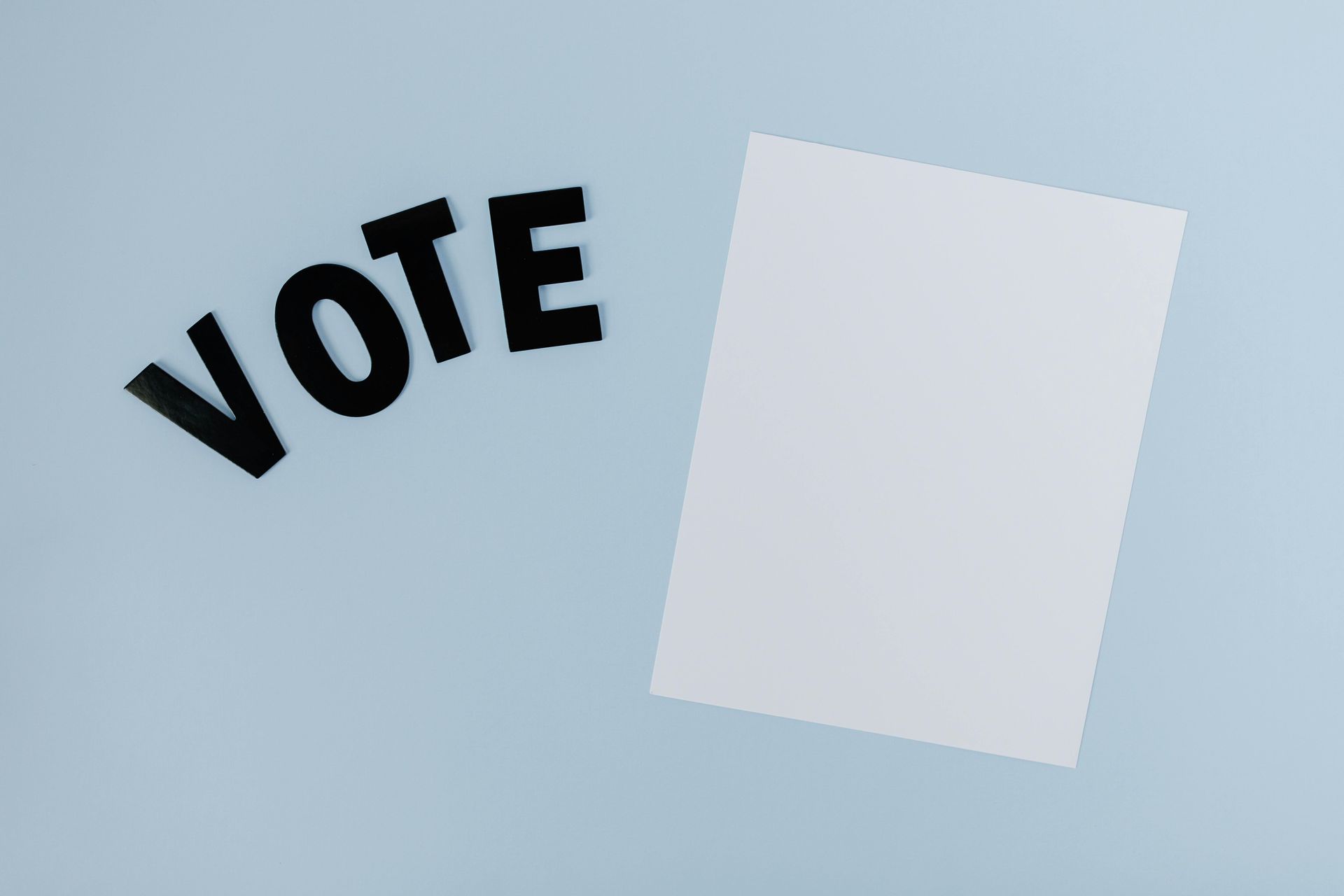 Black letters spelling VOTE and a blank piece of paper