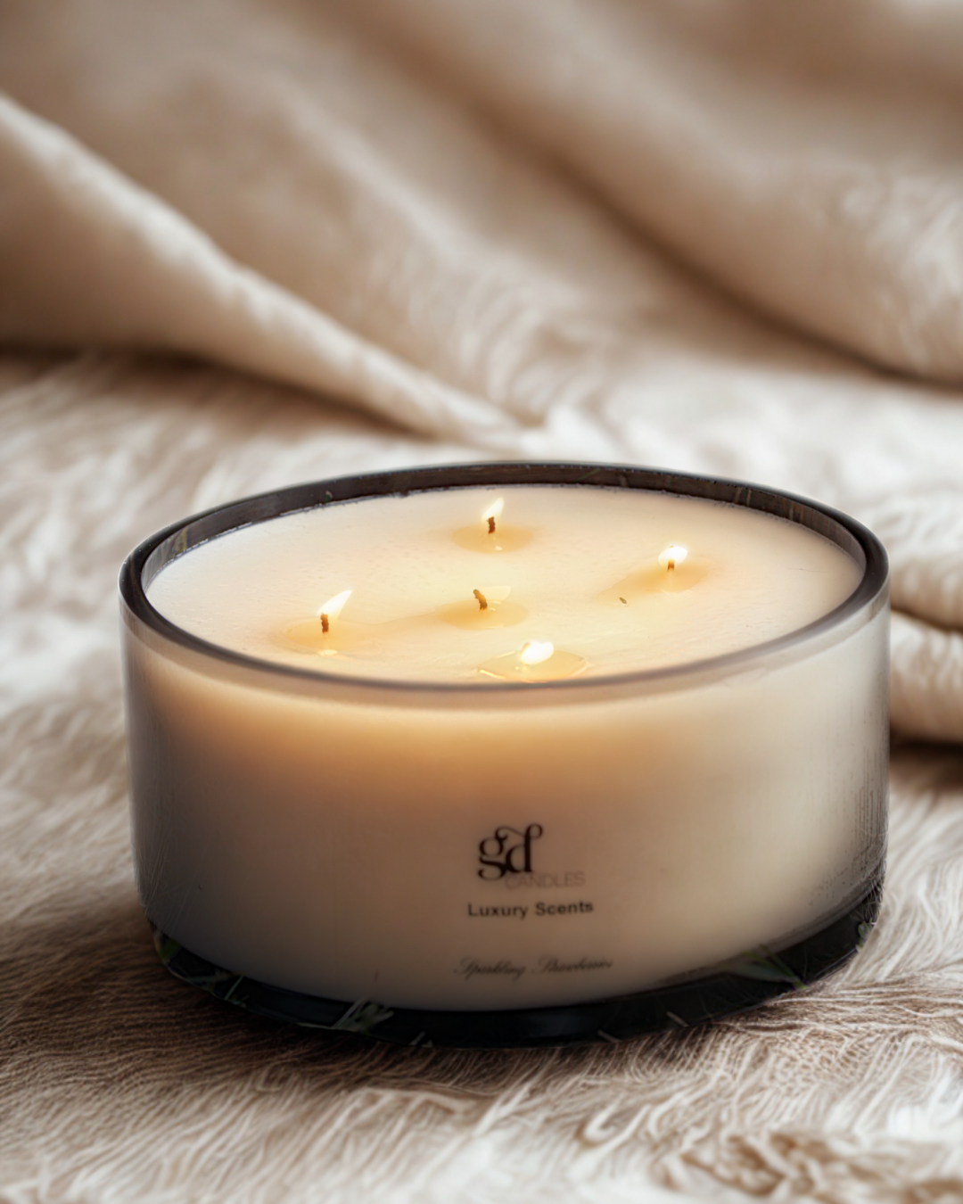 GD Events signature hand-poured soy candle with multiple wicks, elegantly styled on a soft fabric surface — perfect for corporate and client gifting.