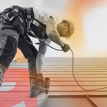 A roofer on top of the roof with orange background