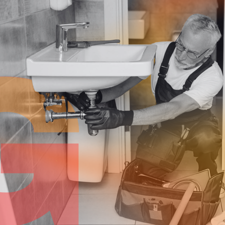 A man fixing sink with orange background