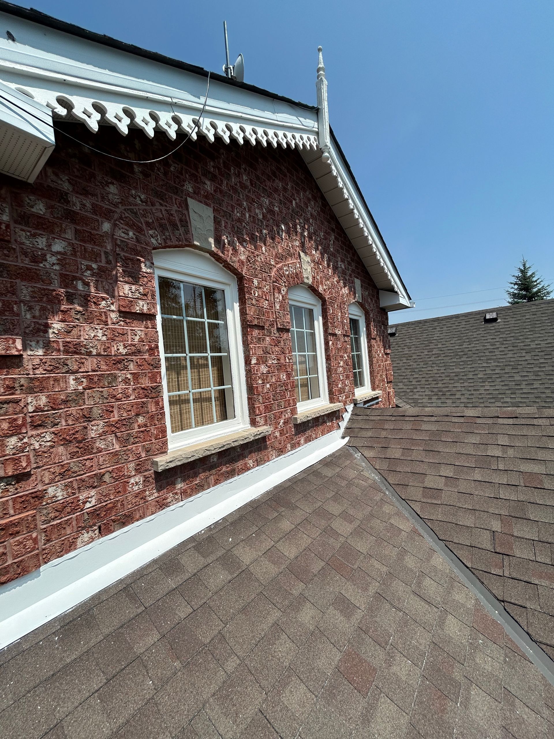 A hallway with white cabinets and a wooden ceiling leading to a kitchen.