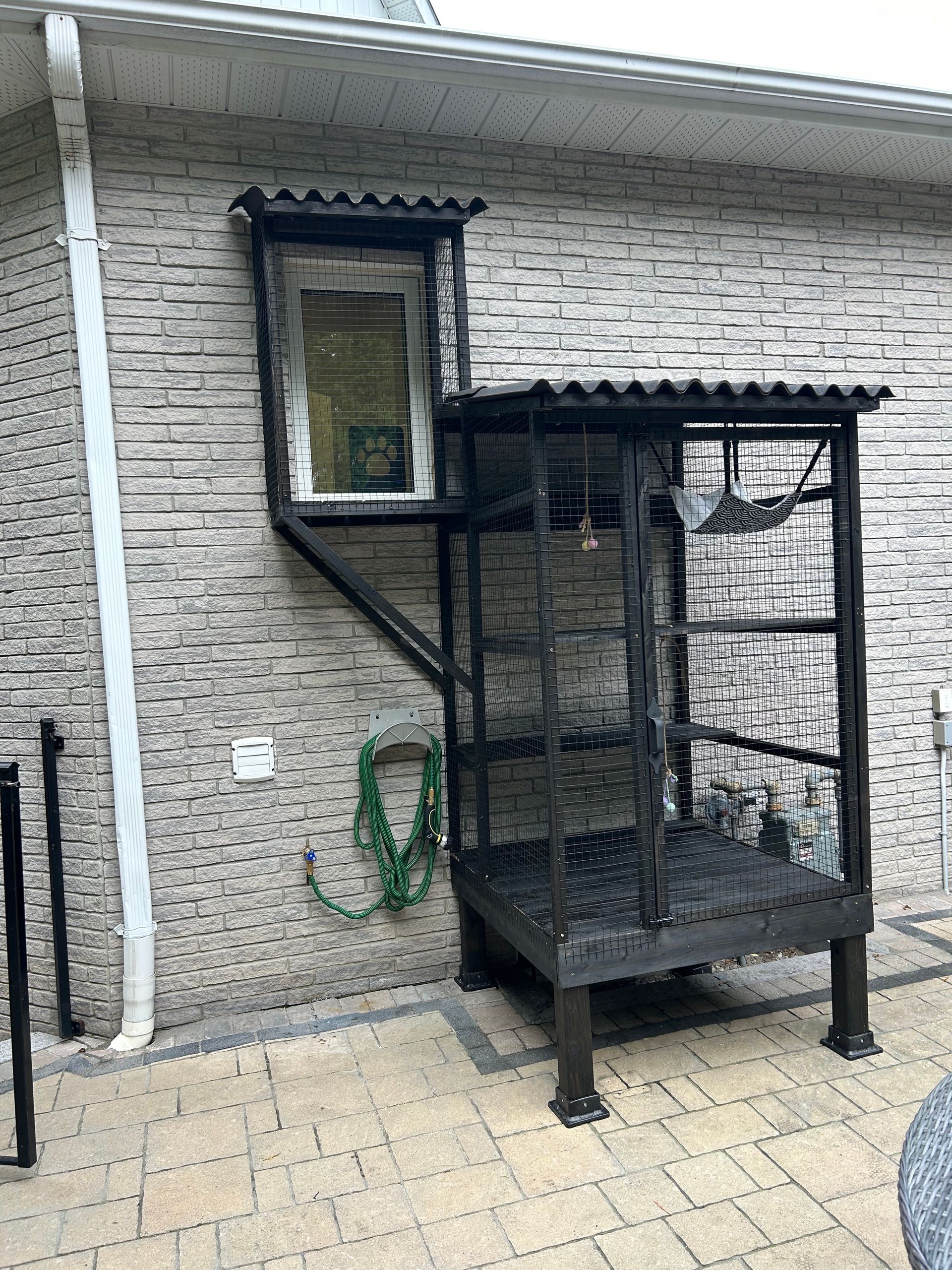 A brick building with a staircase leading up to it and a window.
