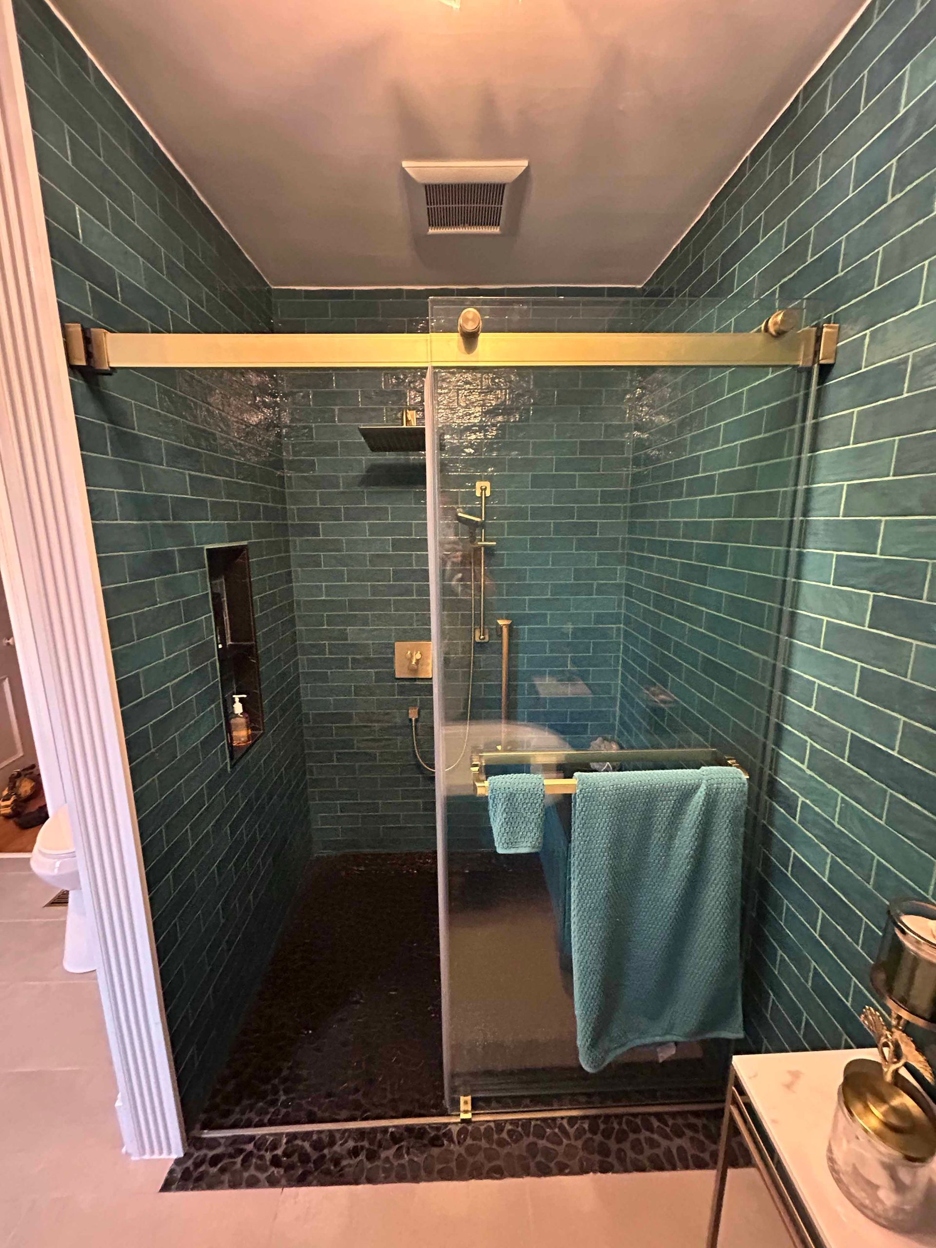 A wooden birdhouse is hanging from a tree in a yard.