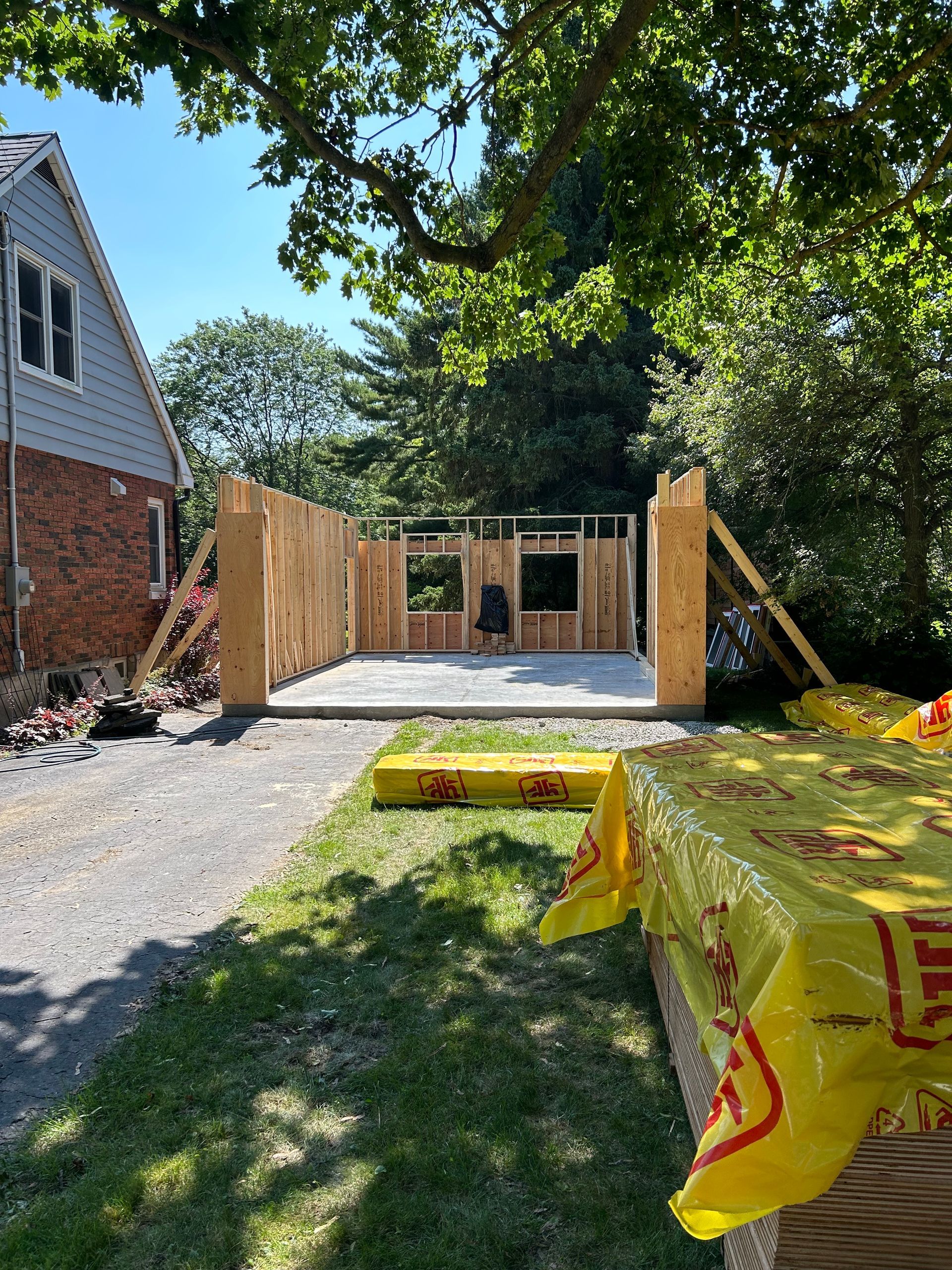 A house is being built in the backyard of a house.