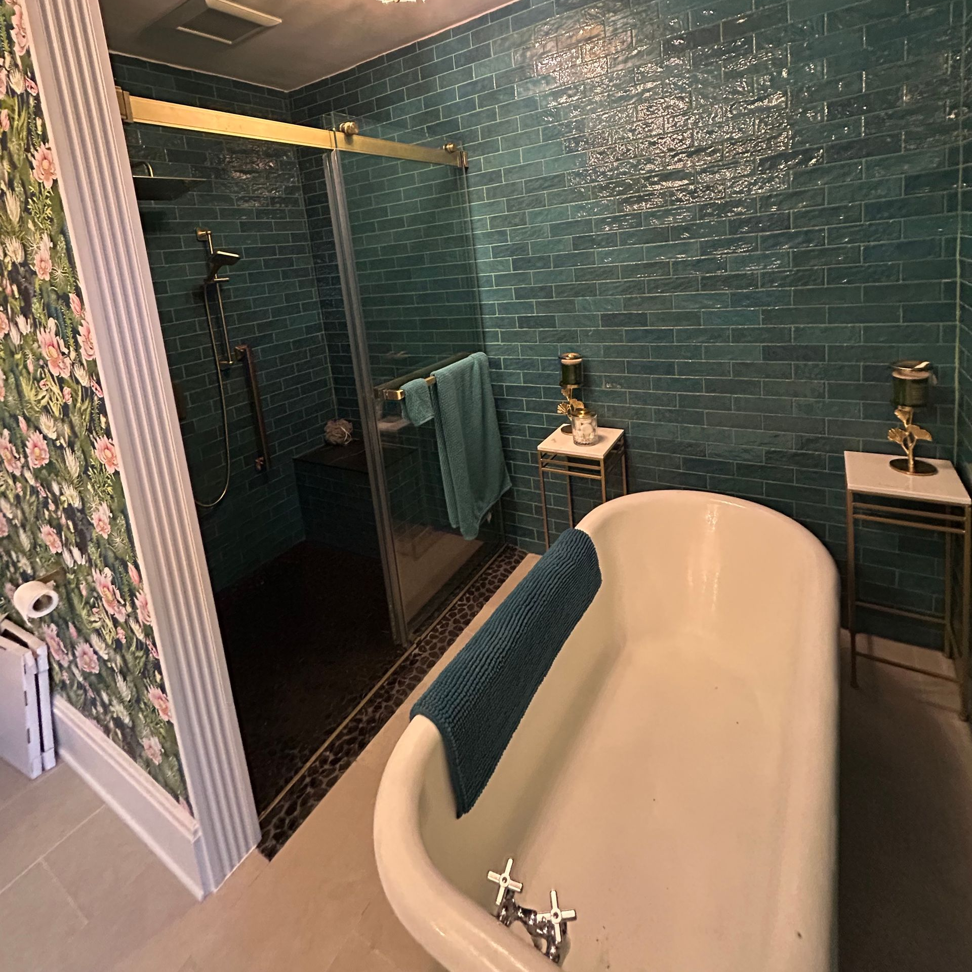 A hallway with a white door and a table with a hat on it.