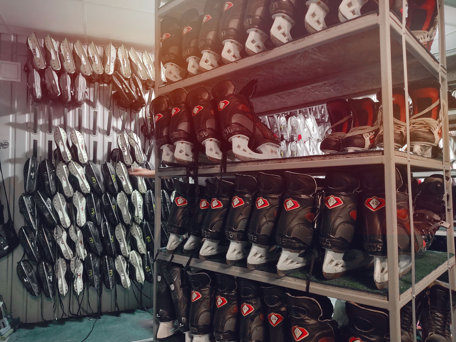 A warehouse filled with lots of ice skates and helmets.