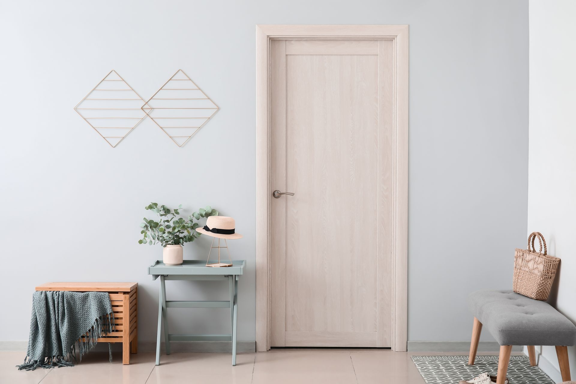 A hallway with a white door and a table and chairs.