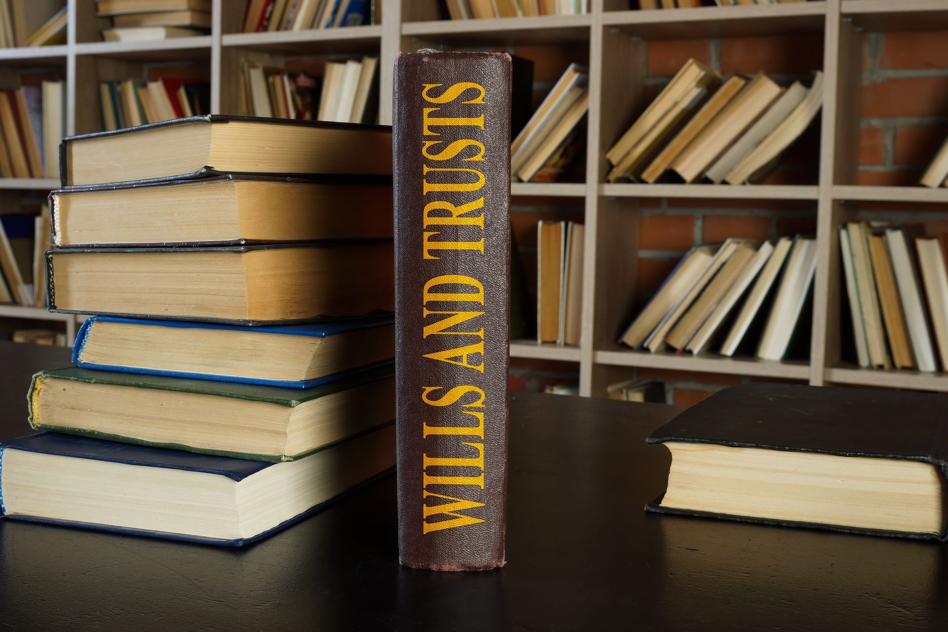 Books on a table: Stack of books beside a single book that says 