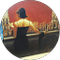 A woman is standing in front of a red wall in a circle.
