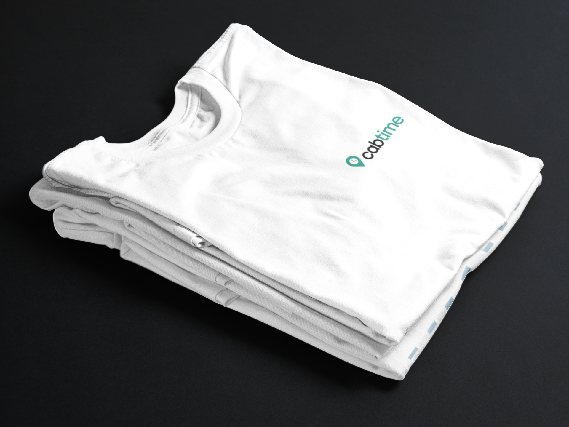 White CabTime logo t-shirts are stacked on top of eachother