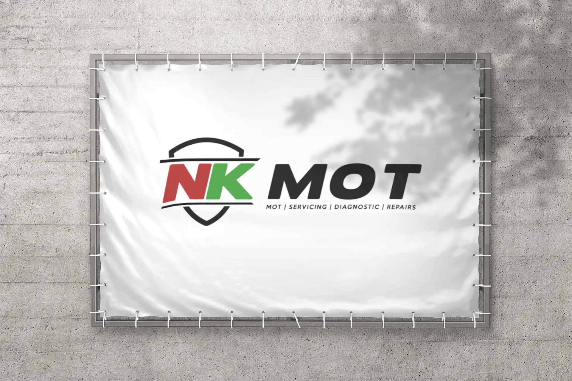 A white banner with the NK mot logo on it