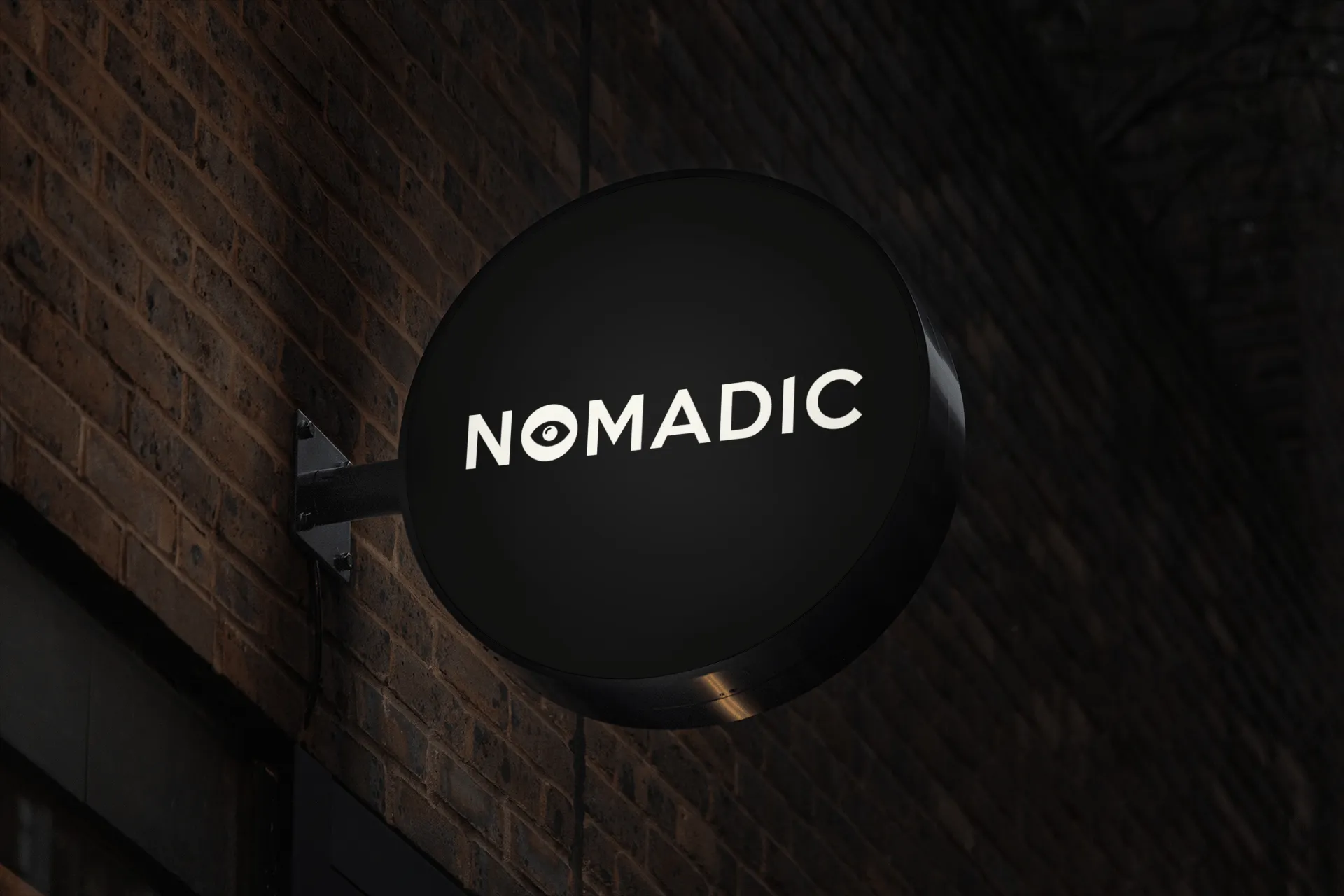 A black sign with the Nomadic Logo