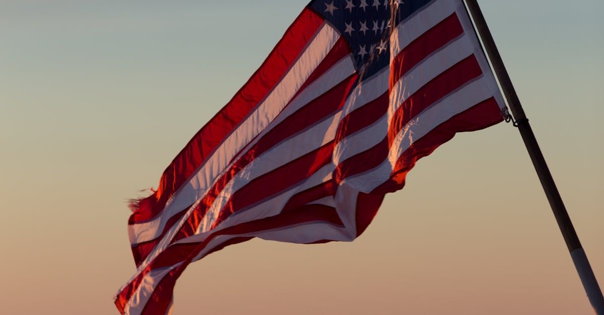 A close up of an american flag waving in the wind.