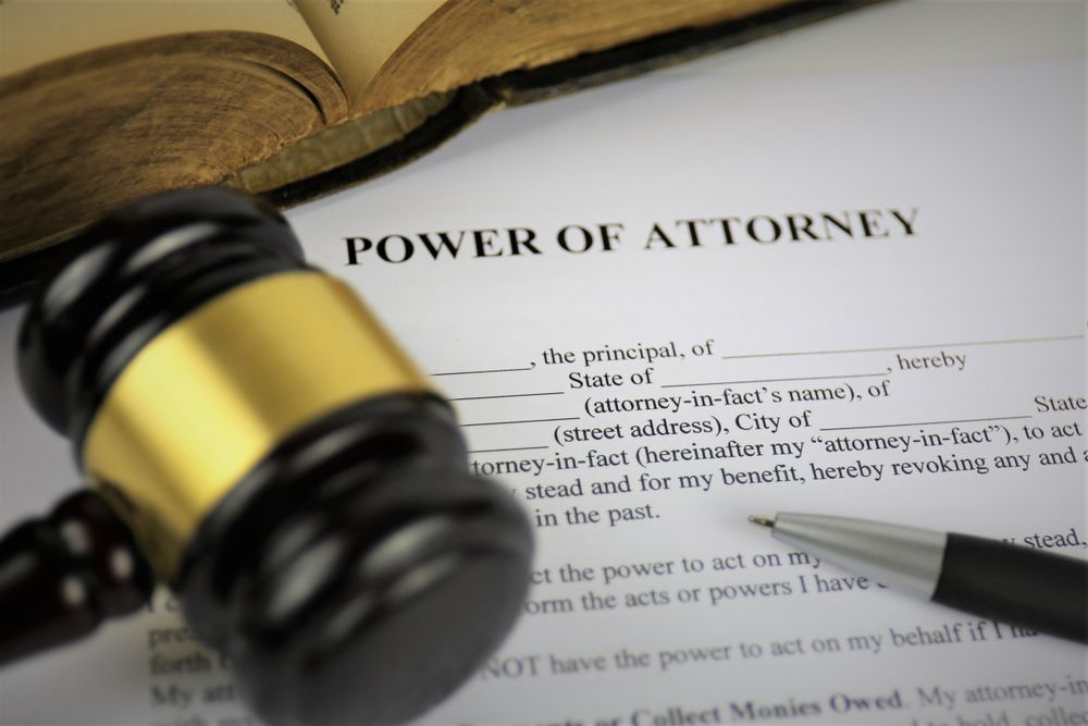 A gavel is sitting on top of a power of attorney