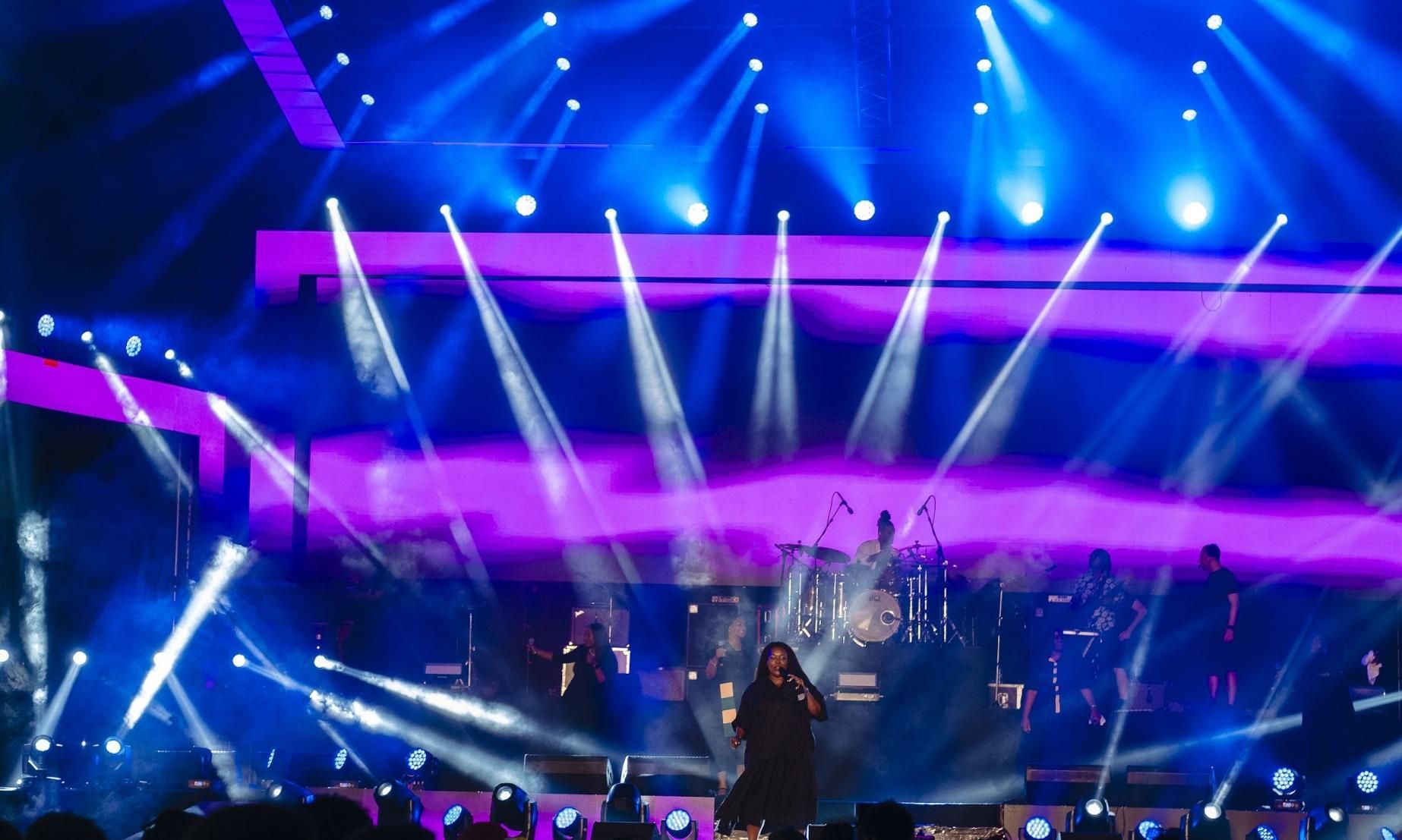 Concert stage lit with blue and purple lights; band performing, Chevelle at the center.